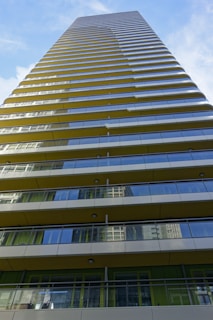 A panoramic view of a high-rise building with balconies overlooking the city.