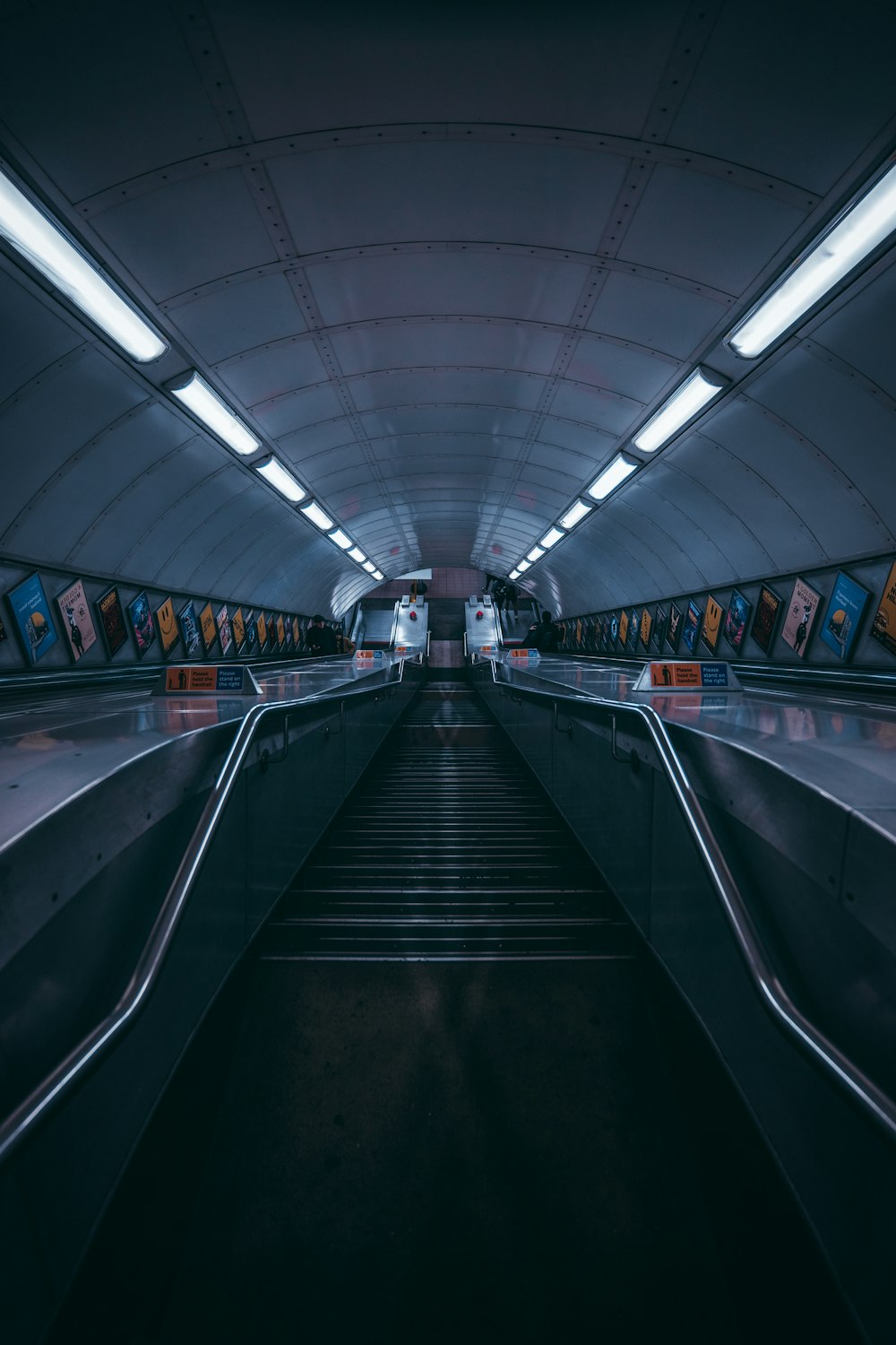 an escalator in a subway station at night