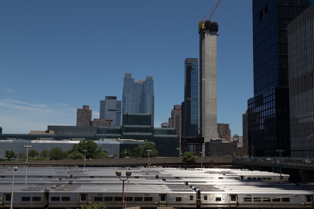 a train traveling through a city next to tall buildings