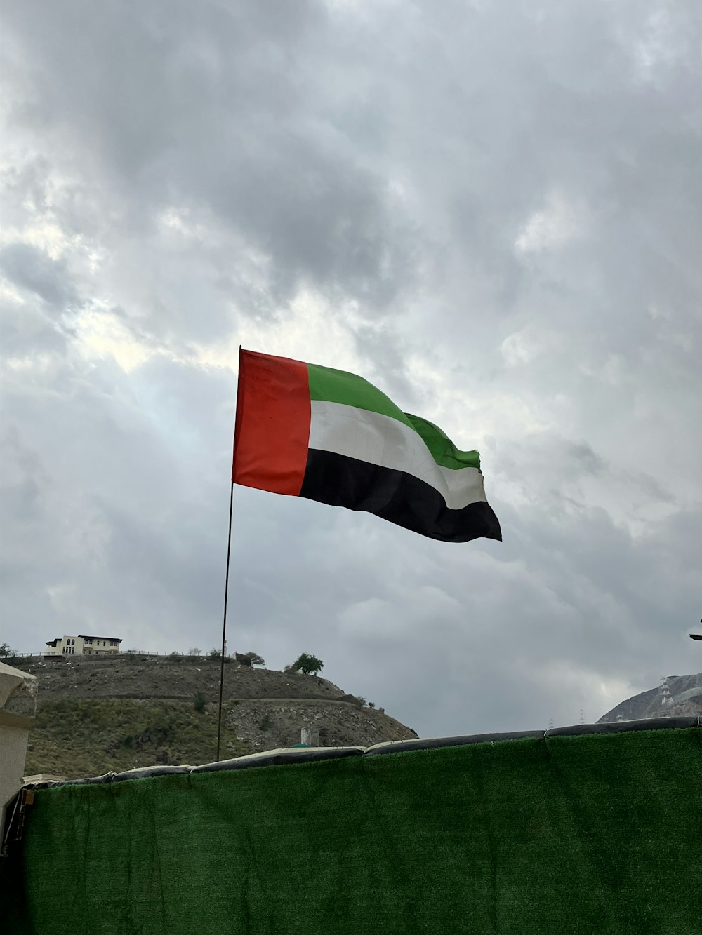 a flag flying in the wind on a cloudy day