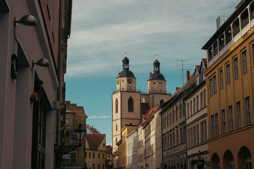 a city street lined with tall buildings and a clock tower