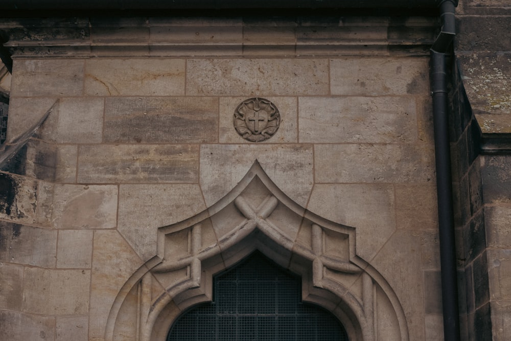 a stone building with a clock on the front of it