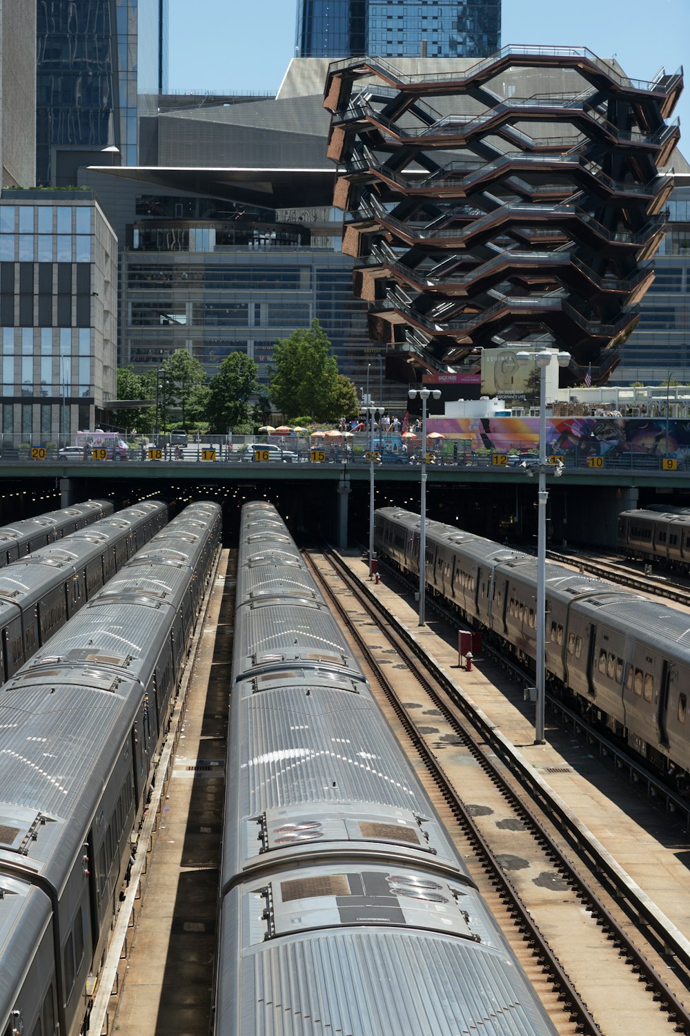 a train yard with several trains on the tracks