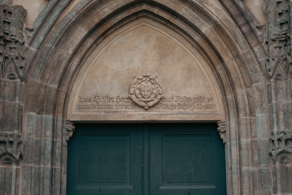 a green door with a coat of arms on it