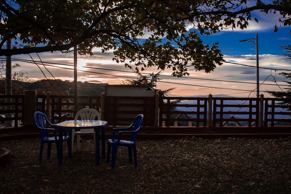 a table and chairs sitting on top of a field