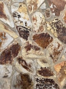 Close-up of textured stone wall cladding in a stylish home office.