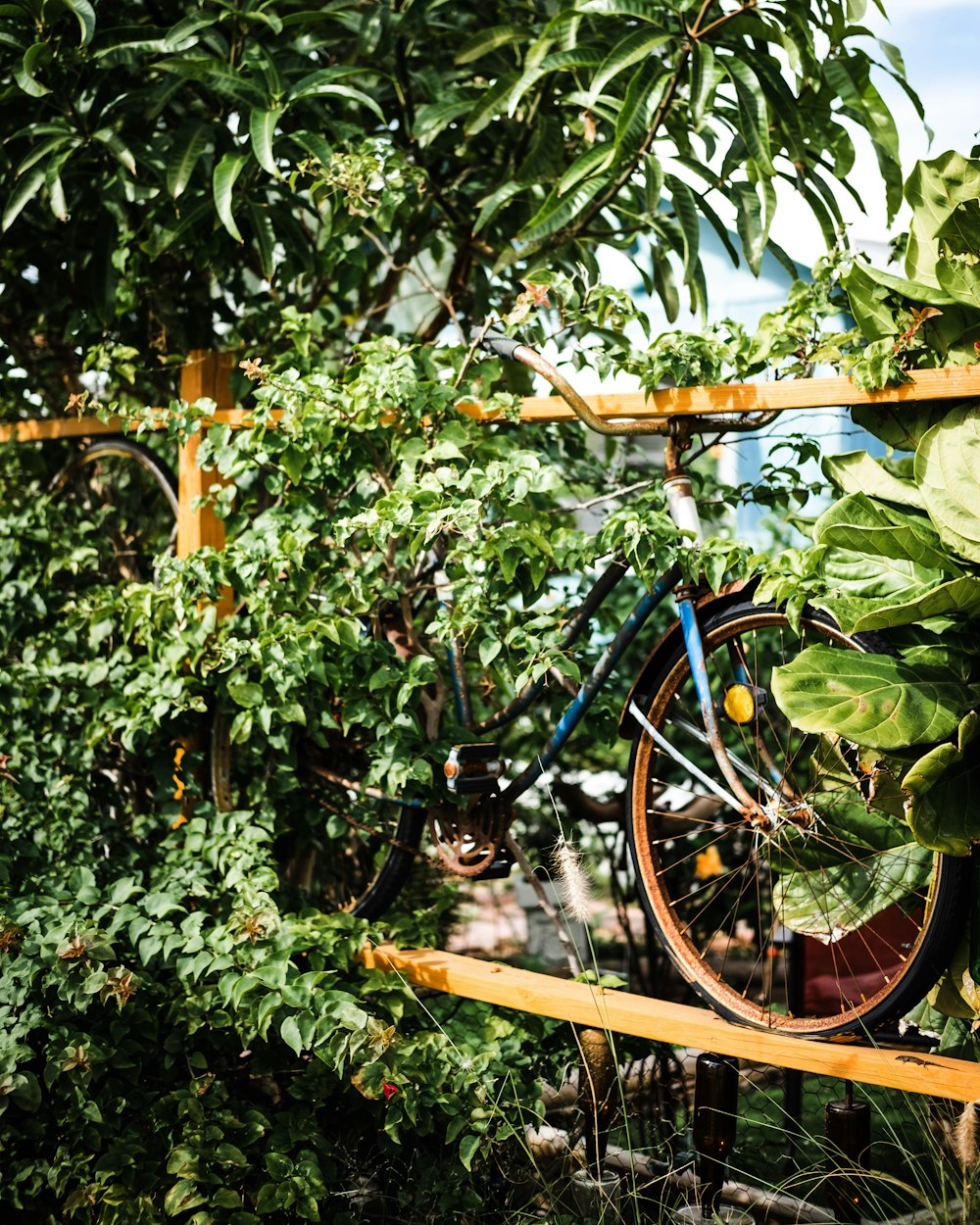 a bicycle that is hanging from a wooden rack