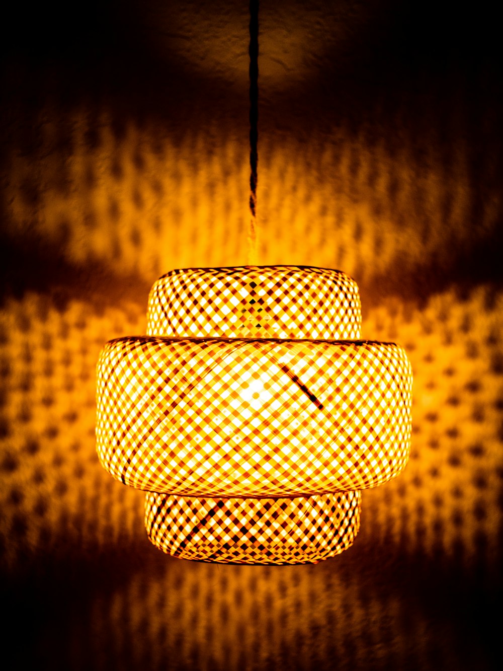 a yellow light hanging from a ceiling in a room