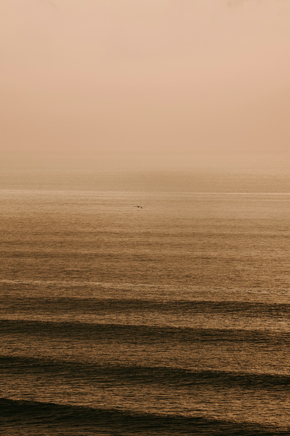 a large body of water sitting under a cloudy sky