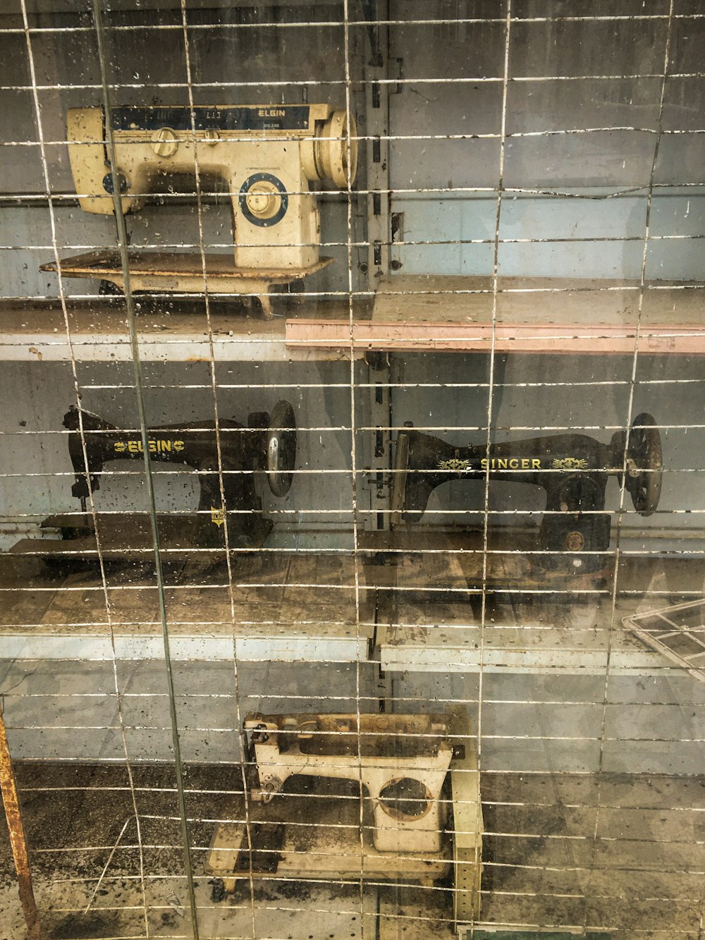 a couple of old sewing machines sitting in a room