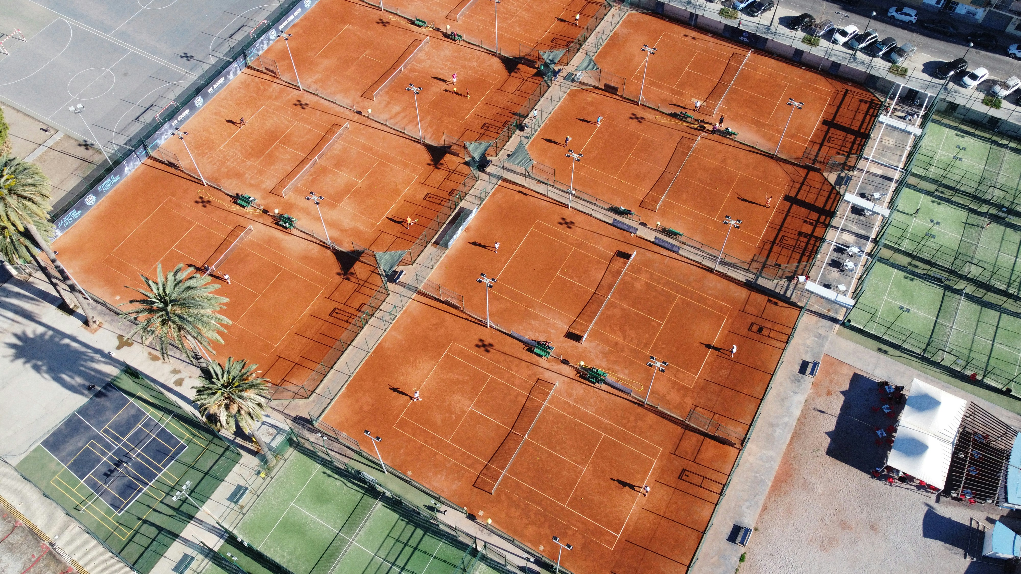 an aerial view of a tennis court with orange tarps