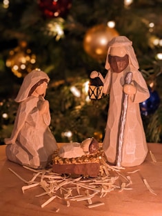 a nativity scene of a manger scene with a baby jesus in a man