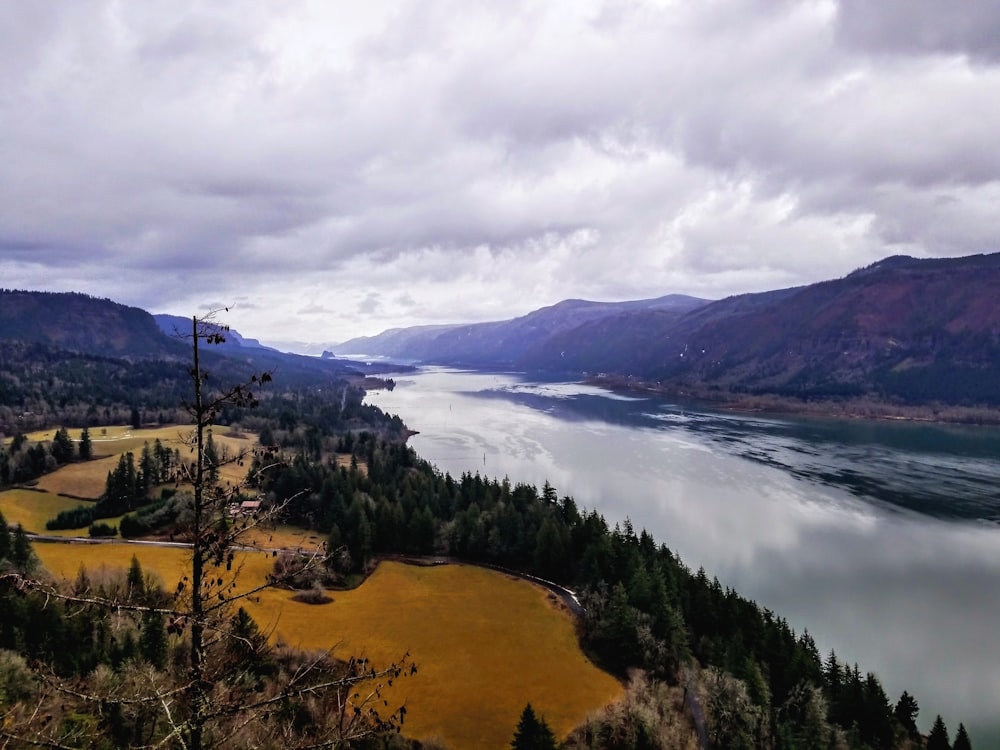 a scenic view of a lake surrounded by mountains