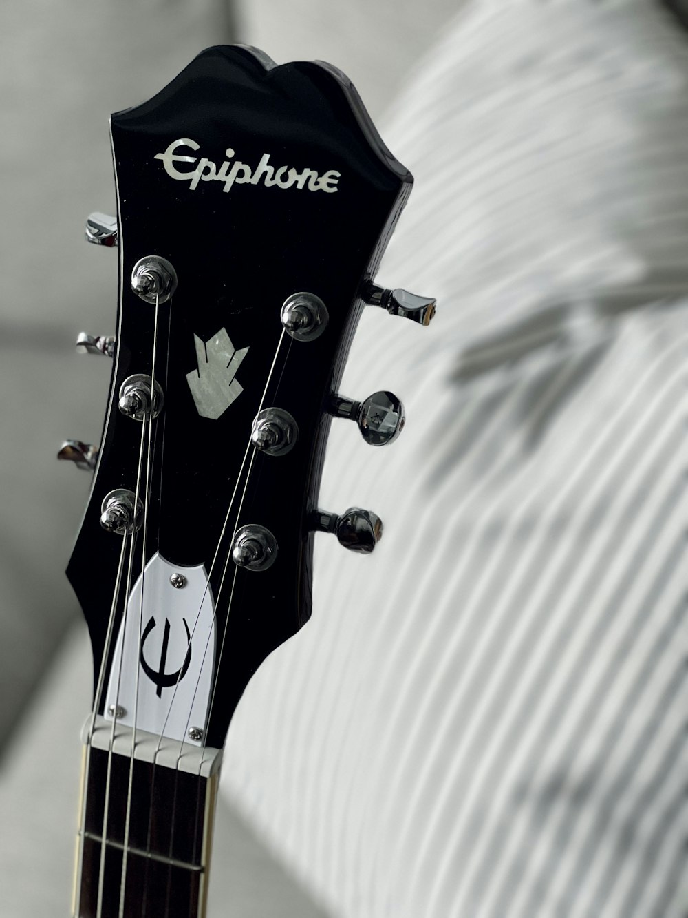 a close up of a black guitar head