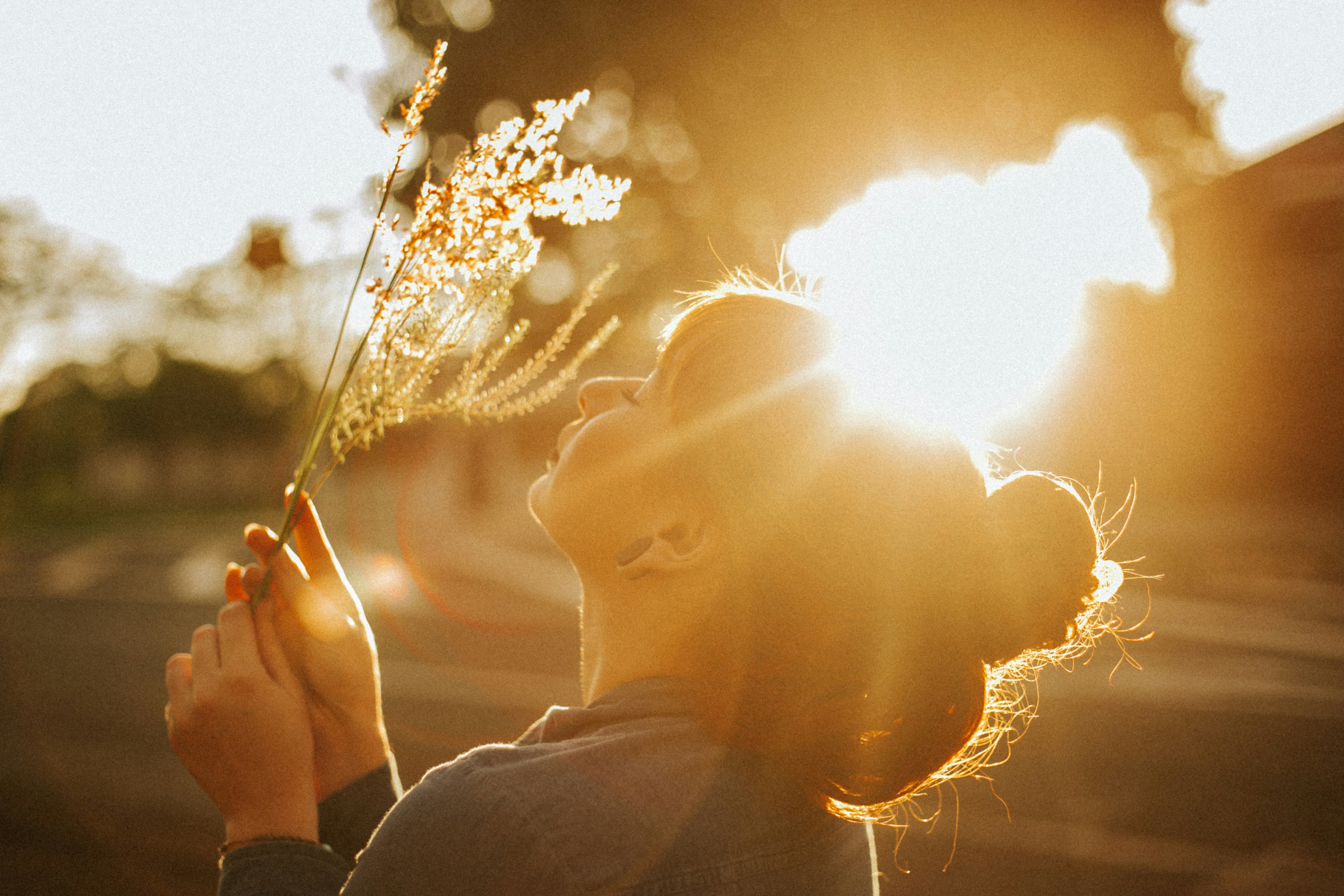 a woman holding a flower in her right hand