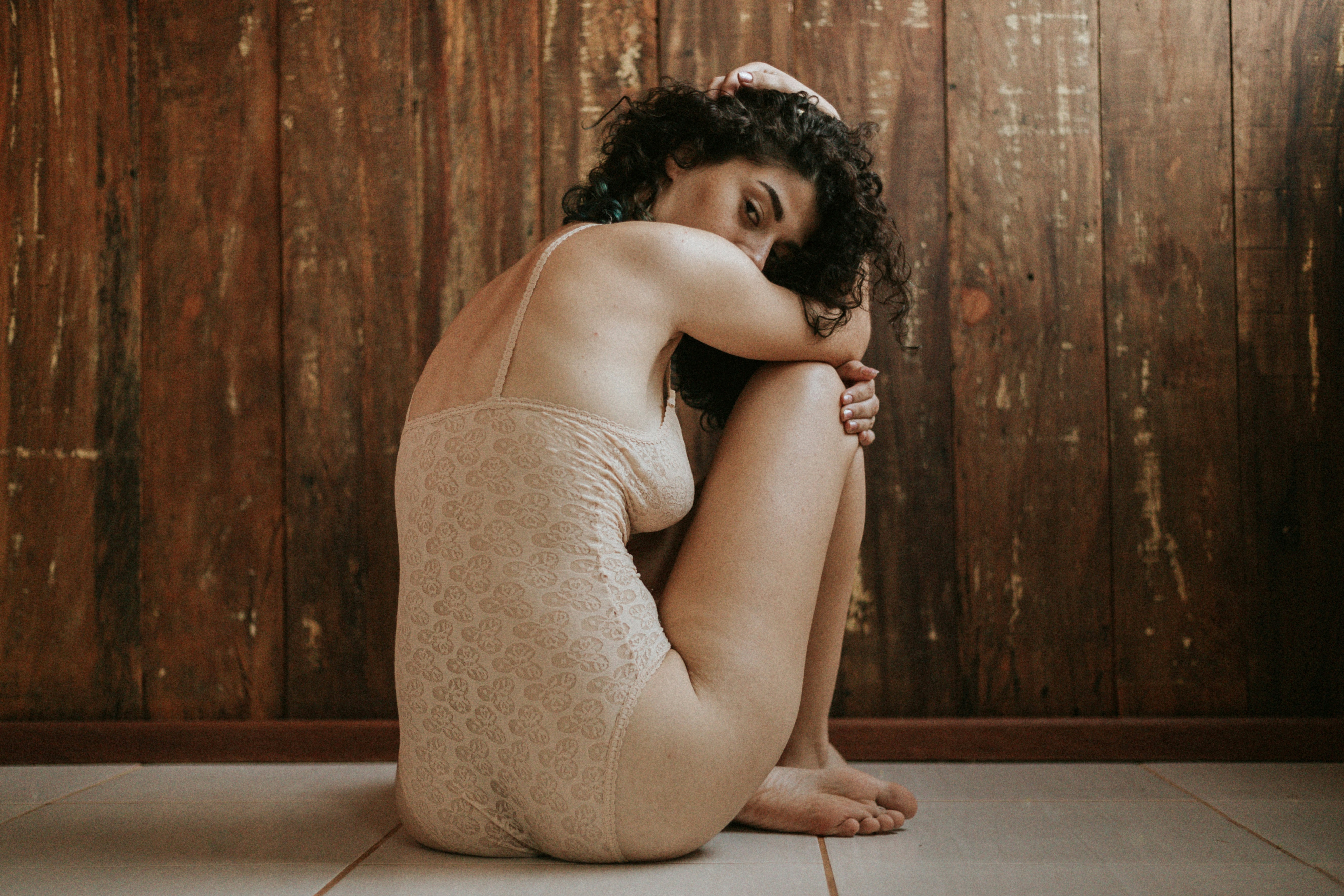 a woman sitting on the floor with her legs crossed