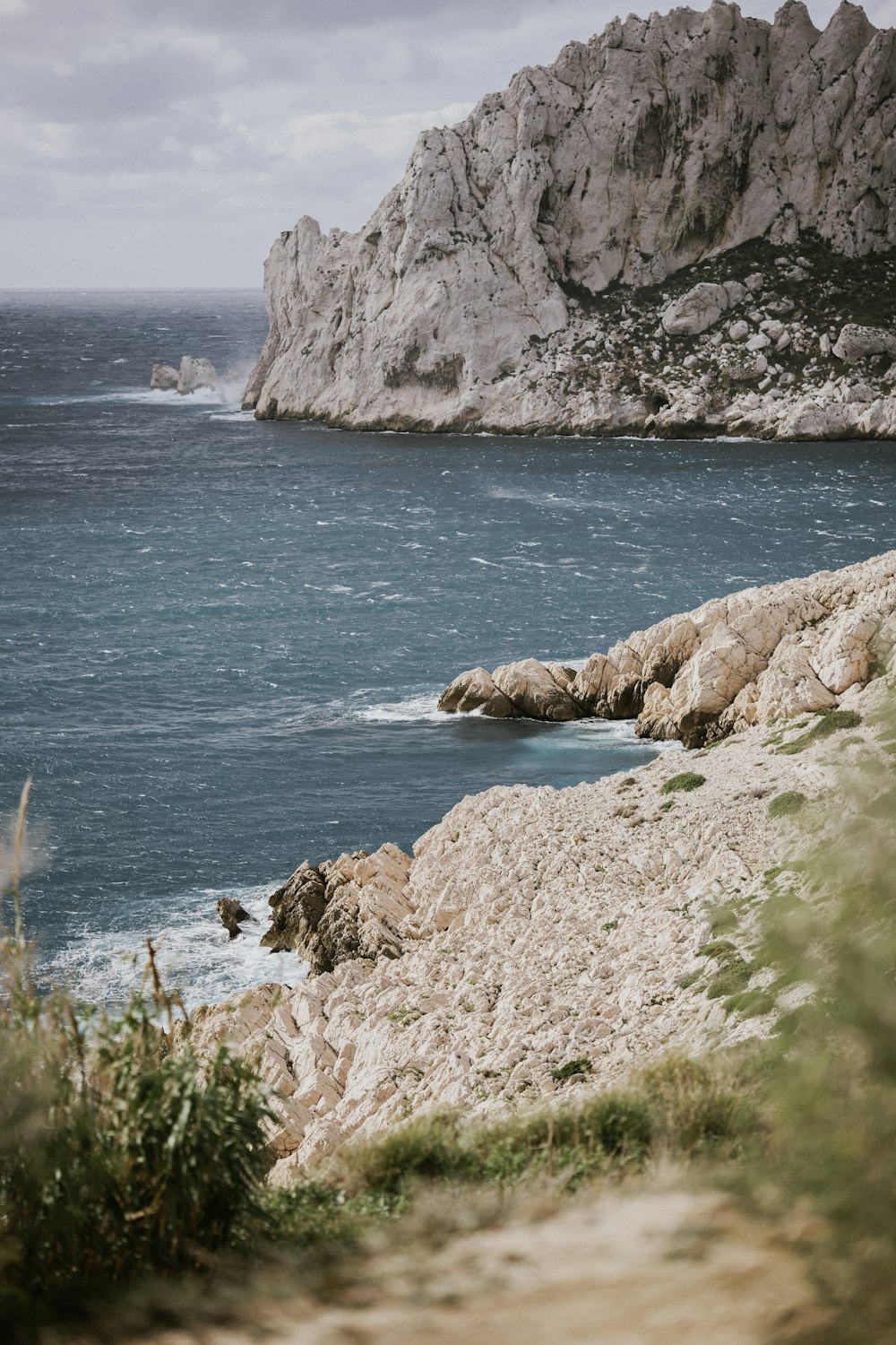 a large rock outcropping next to a body of water