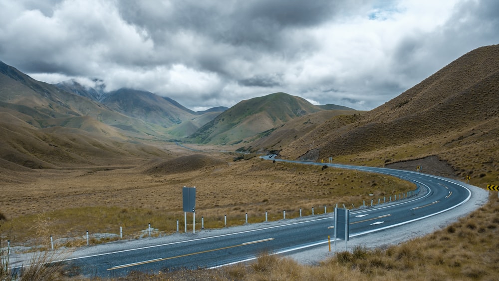 a winding road in the middle of a mountain range