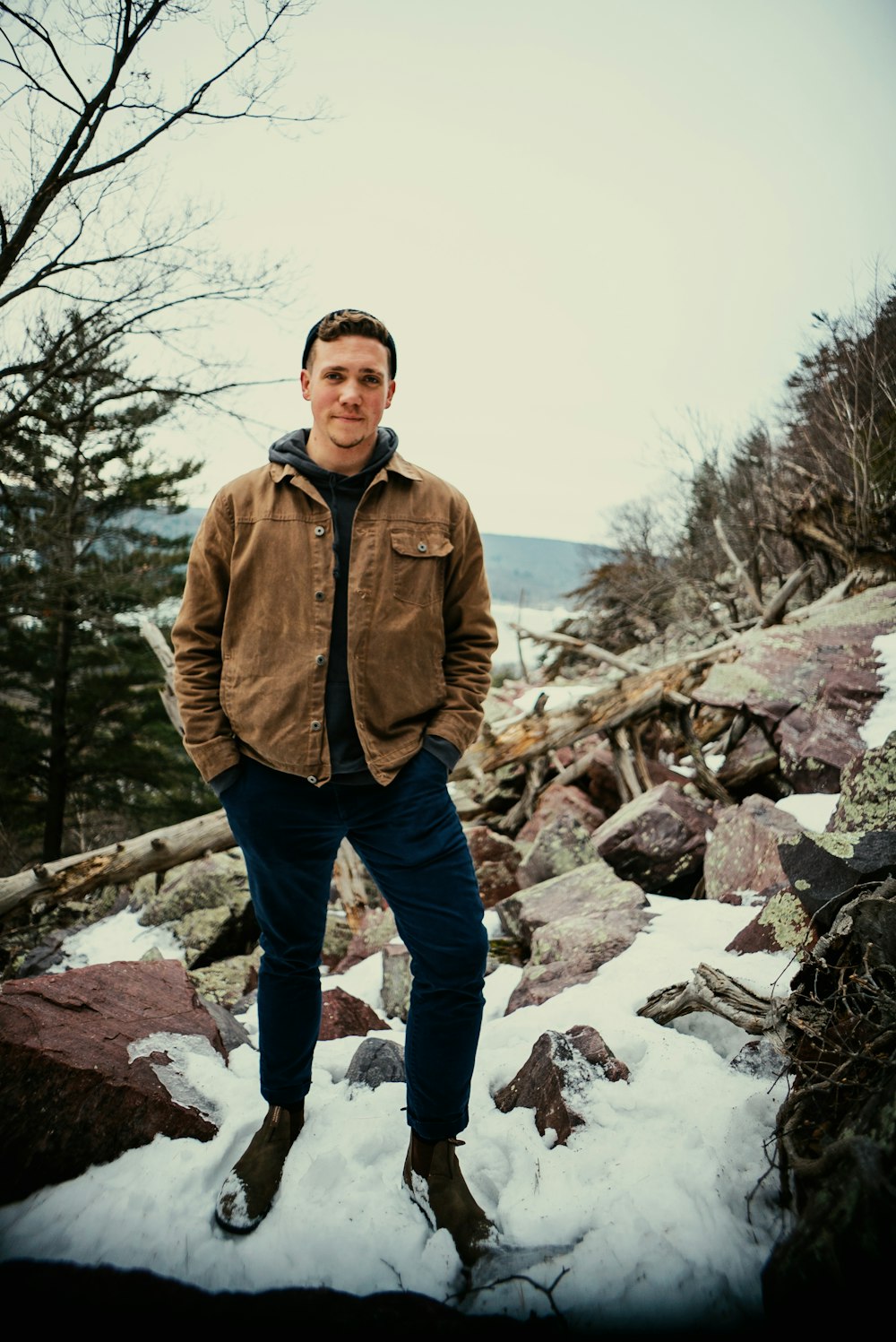 a man standing on top of a pile of snow