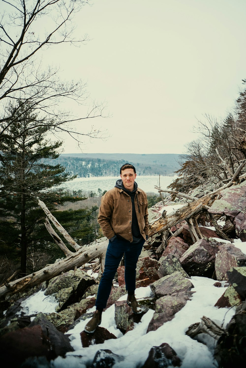 a man standing on top of a pile of rocks