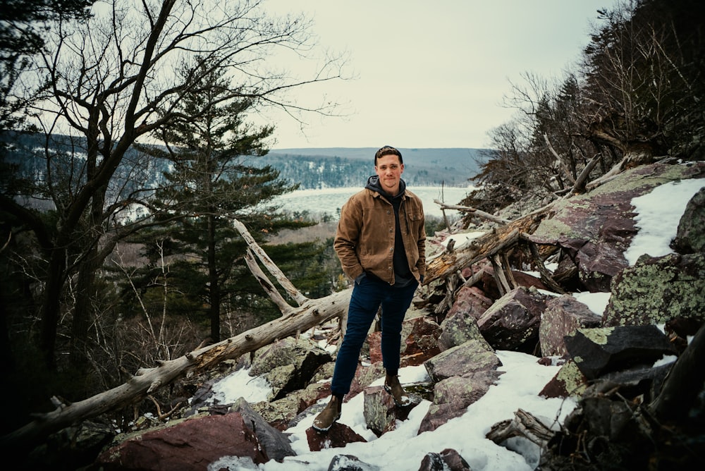 a man standing on top of a pile of rocks