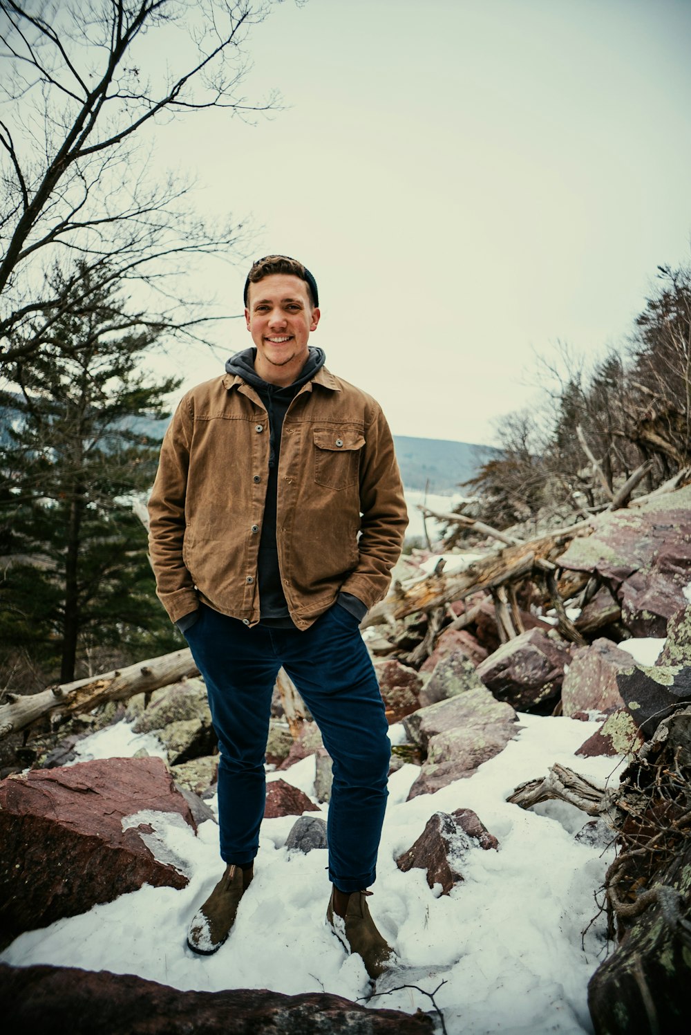 a man standing on top of a pile of snow