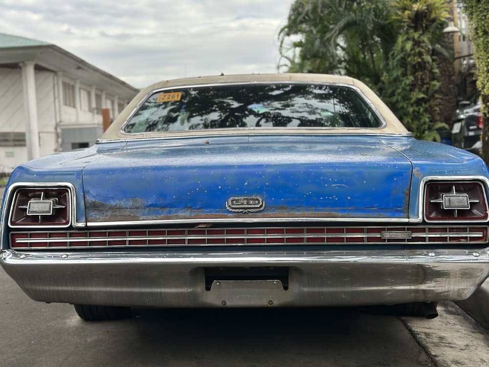 a blue car parked on the side of the road