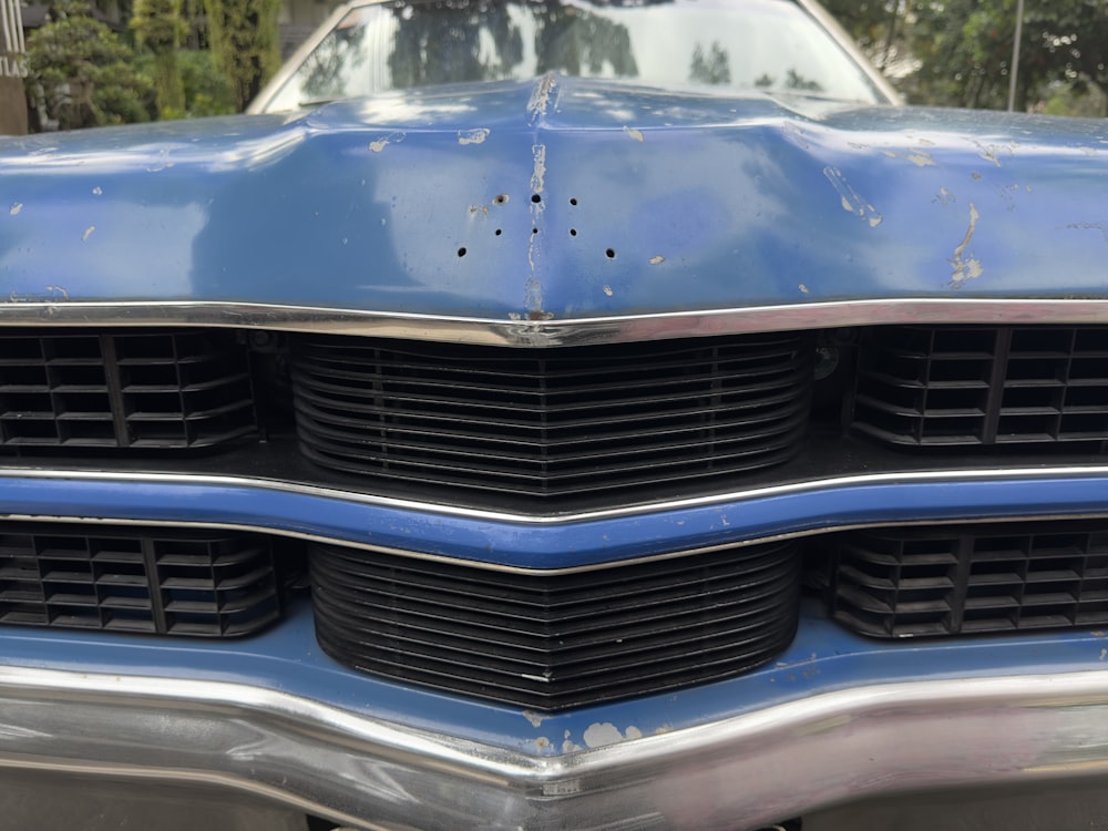 a close up of the front of a blue car