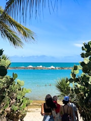 a couple of people that are standing in the sand