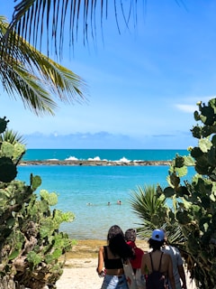 a couple of people that are standing in the sand