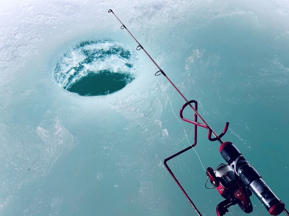 a fishing rod is attached to a boat in the water