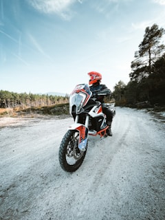 a person riding a motorcycle on a dirt road