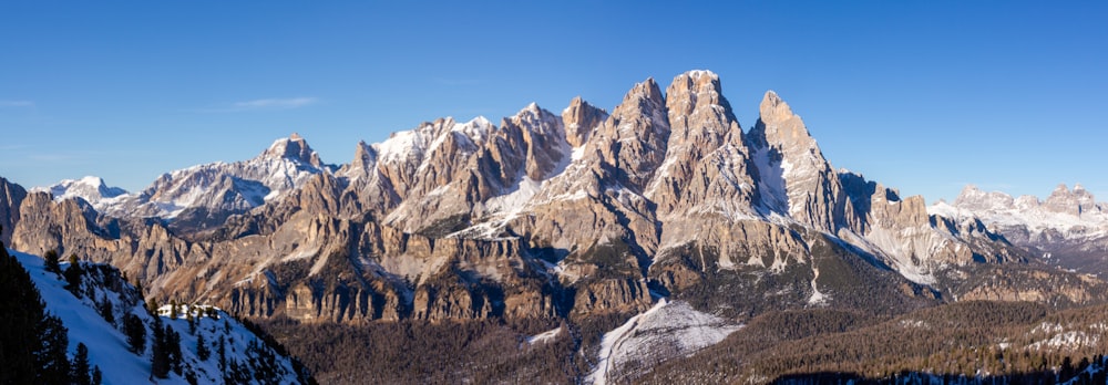 a mountain range with snow covered mountains in the background