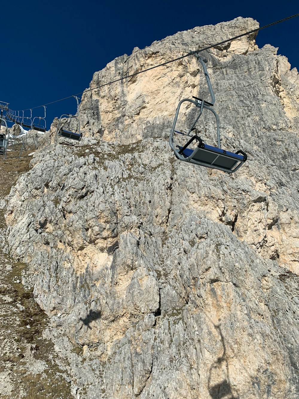 a ski lift going up the side of a mountain