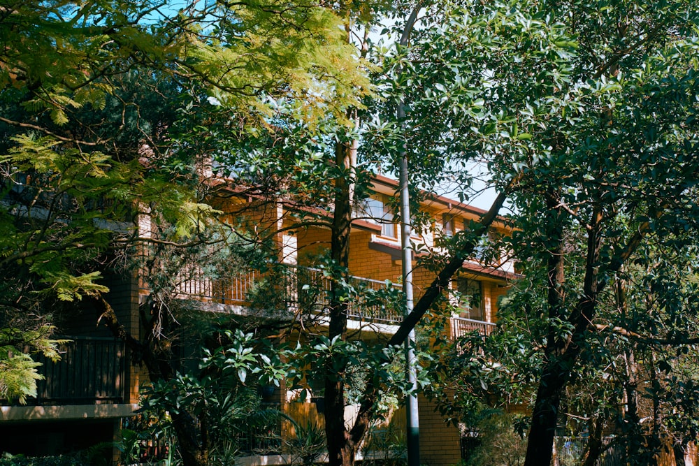 a building with a balcony surrounded by trees