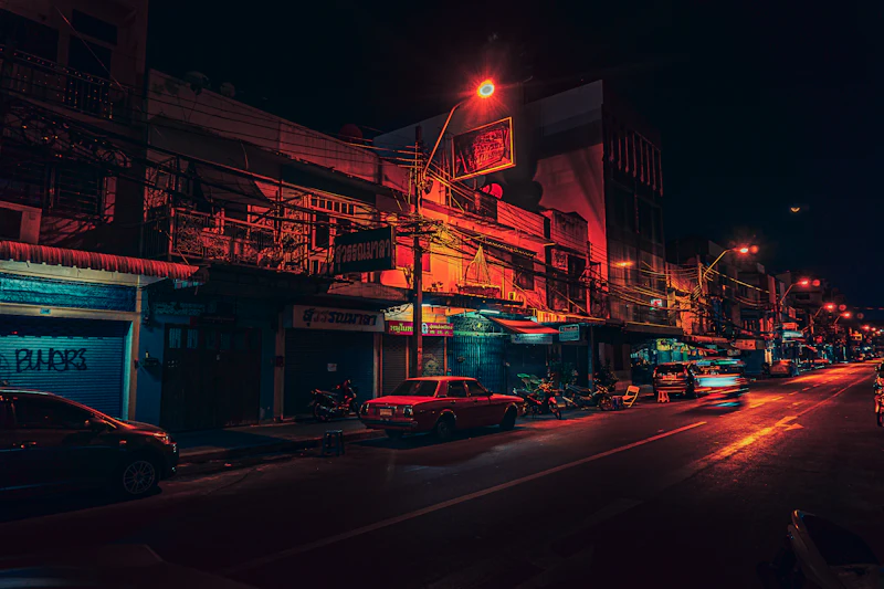 Warm lights in a narrow Old Bangkok lane after dark