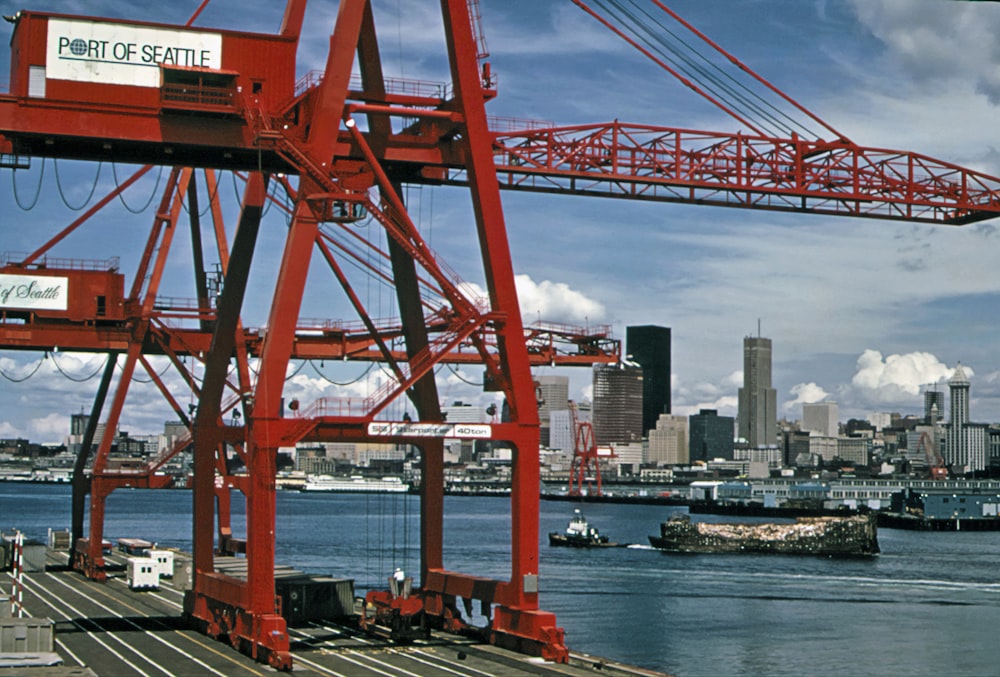 a large red crane sitting on top of a bridge