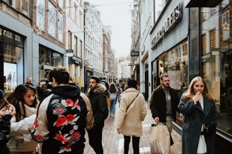 A bustling street scene with people walking and shopping.