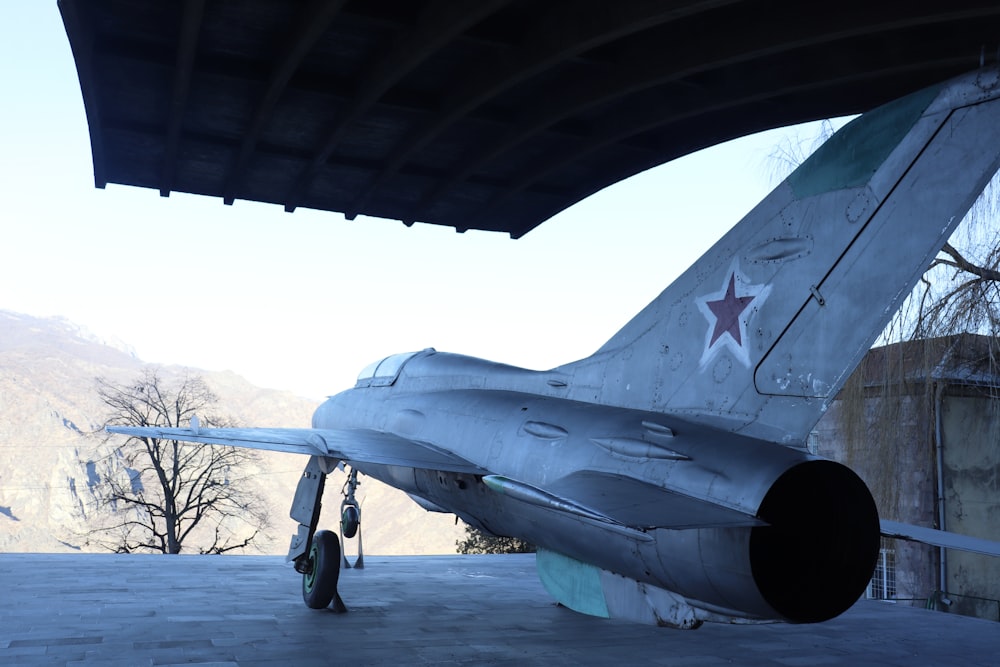 a fighter jet sitting on top of an airport tarmac