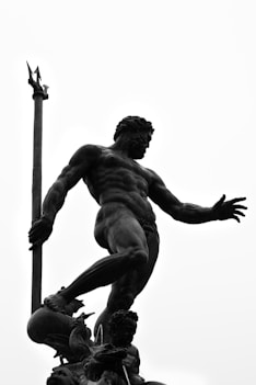 a black and white photo of a statue of a man