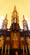 An altar adorned with candles, stones, and carved wooden symbols.