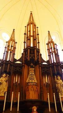 An altar adorned with candles, stones, and carved wooden symbols.