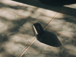 A smooth, modern charging case with subtle reflections highlighting its premium finish