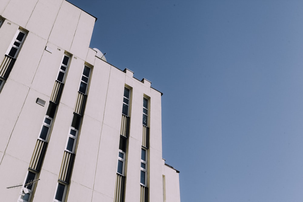 a tall white building with lots of windows