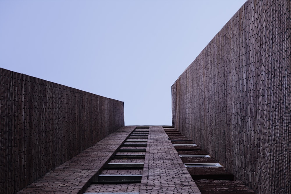 a tall brick building with a sky background