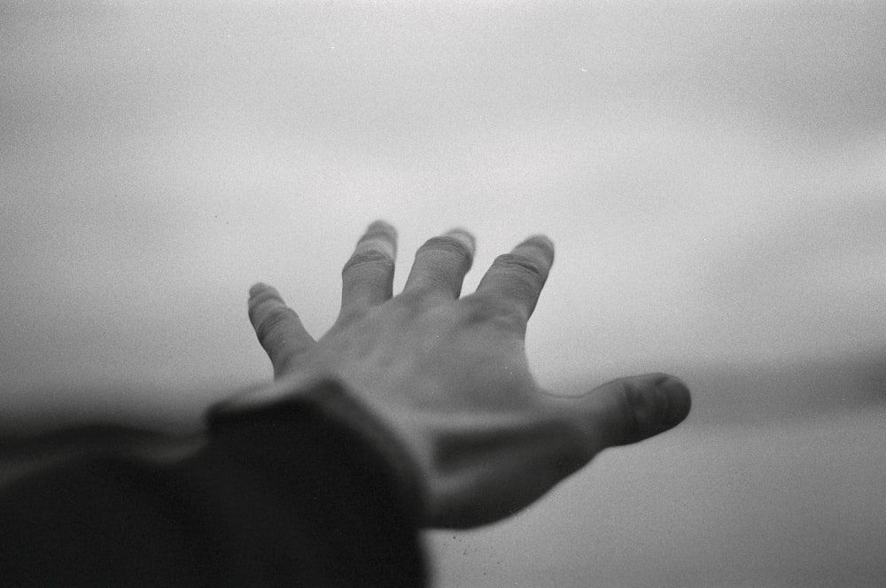 a black and white photo of a person's hand