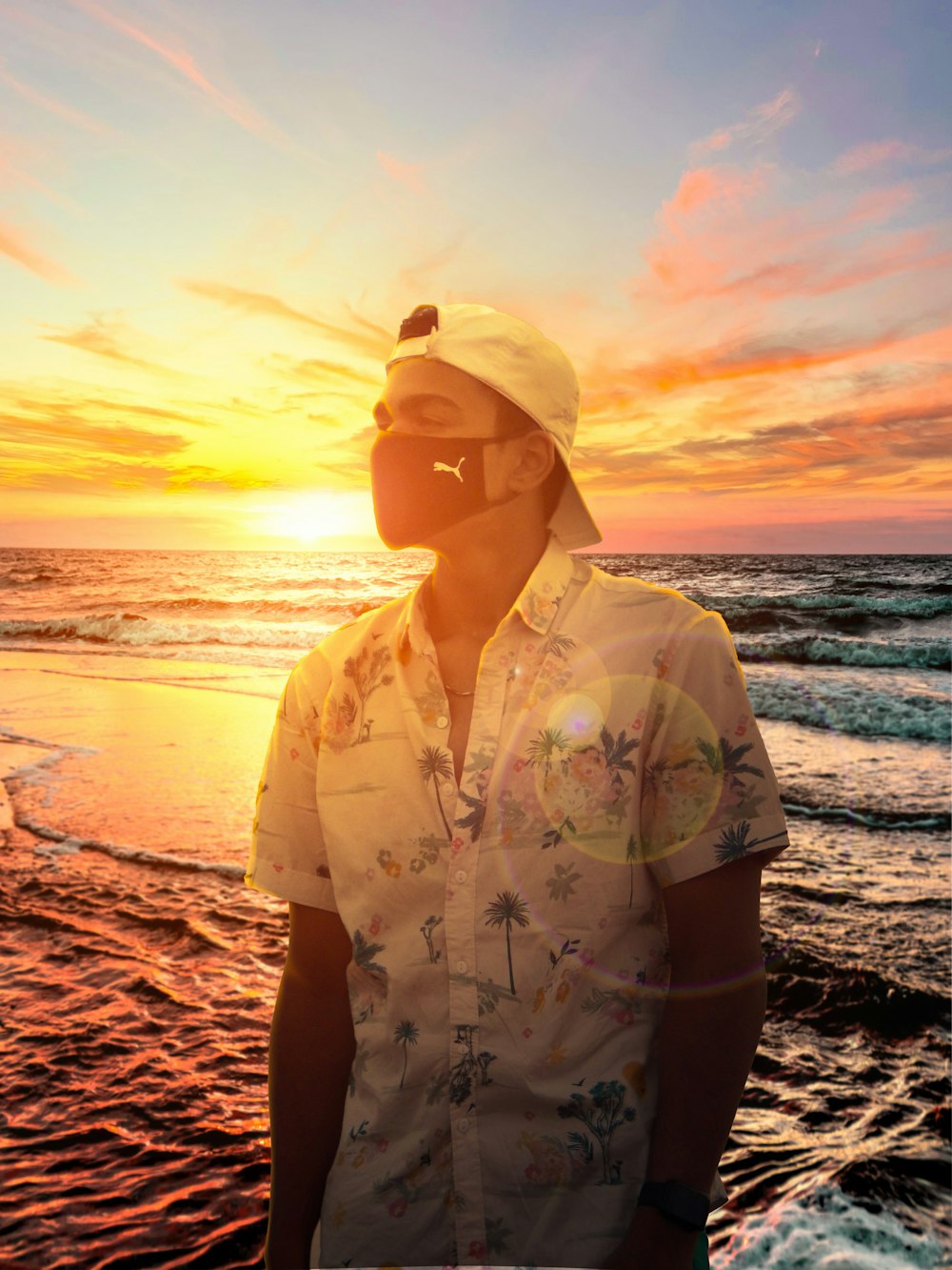 a man standing on a beach next to the ocean