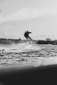a man riding a board on top of a body of water