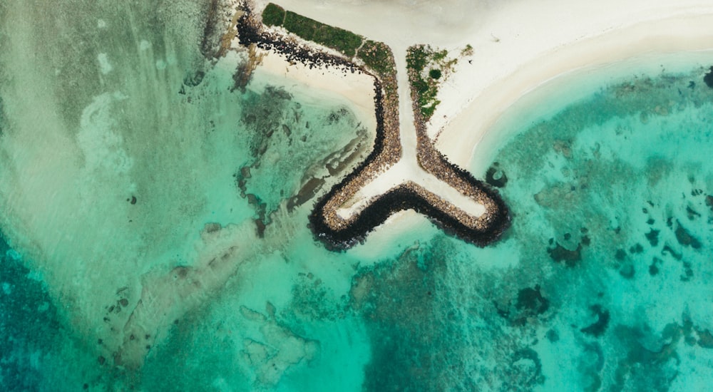 an aerial view of an island with a cross in the middle of it
