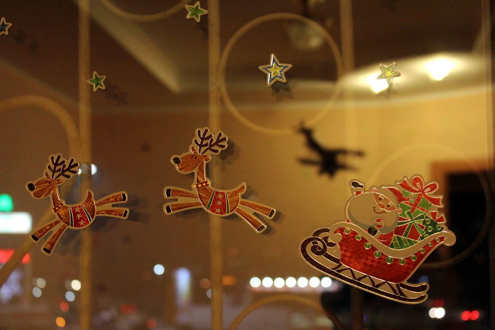 a window with christmas decorations and a santa sleigh
